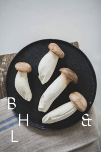 Mushrooms on a black plate on a wooden bench