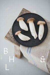 Mushrooms on a black plate on a wooden bench