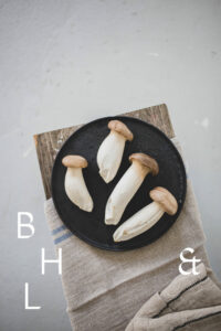 Mushrooms on a black plate on a wooden bench