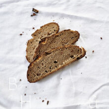 Slices of fresh rustic bread on white background food photography