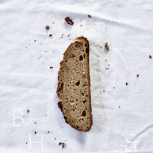 Slices of fresh rustic bread on white background food photography
