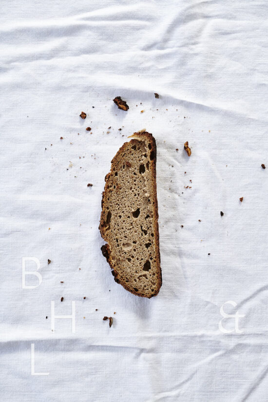 Slices of fresh rustic bread on white background food photography