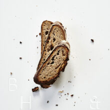 Slices of fresh rustic bread on white background food photography