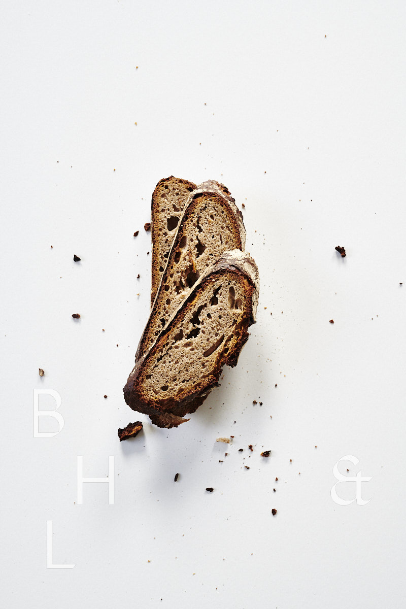 Slices of fresh rustic bread on white background food photography