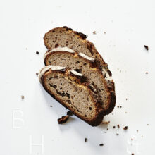 Slices of fresh rustic bread on white background food photography