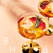 Closeup of summer cocktails and drinks with blood orange and rosemary on coral background