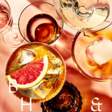 Summer cocktails with blood orange and grapefruit on coral background tabletop