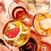 Summer cocktails with blood orange and grapefruit on coral background tabletop