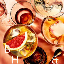 Summer cocktails with blood orange and grapefruit on coral background tabletop