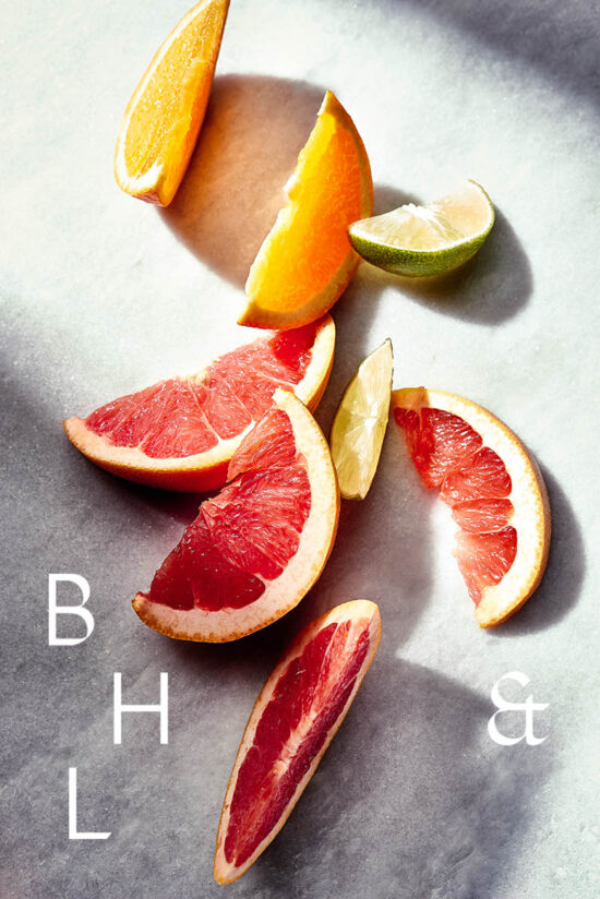 Slices of grapefruit, orange and lime on marble surface
