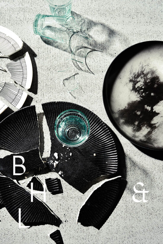 Flatlay of broken plates and glasses on concrete background