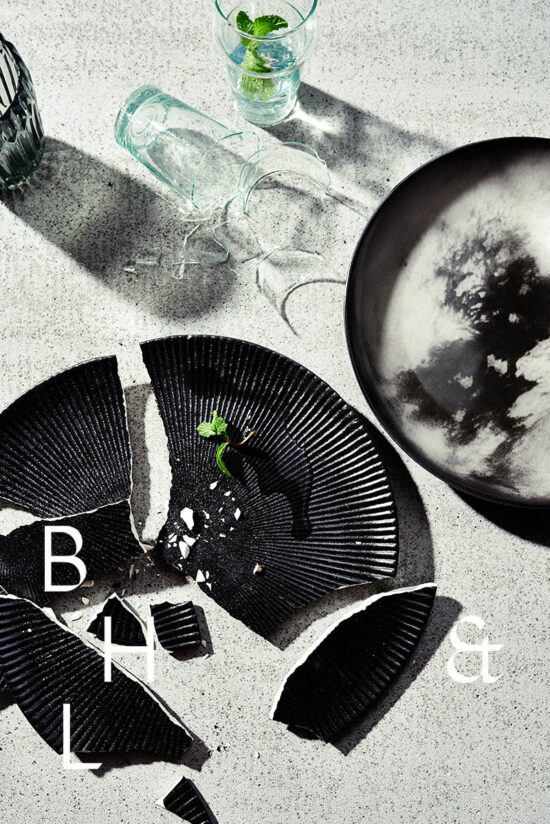 Flatlay of broken plates and glasses on concrete background