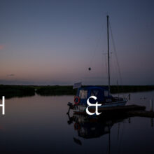 Travel photography of a lake in Poland with a anchor boat and reflections on the water