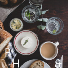 Food photography of a house boat in Poland with a top shot from the table with goat cheese, bread and coffee
