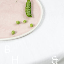 Food photography of a pea pod on a pastel plate on white table clove in perspective