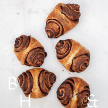 Food photography of some cinnamon rolls on a light marble