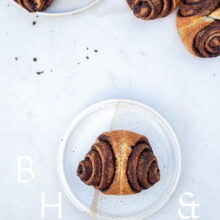 Food photography of some cinnamon rolls on a white plate on marble