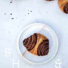 Food photography of cinnamon rolls on a white plate and light marble