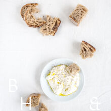 Clean food photography with some bread and burrata and oliveoil