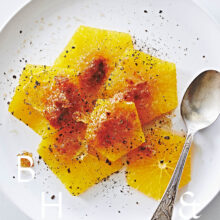 Food photography of caramelized oranges with cinnamon flower