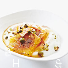 Greek yoghurt with caramelized oranges and pistacchios as dessert - food photography