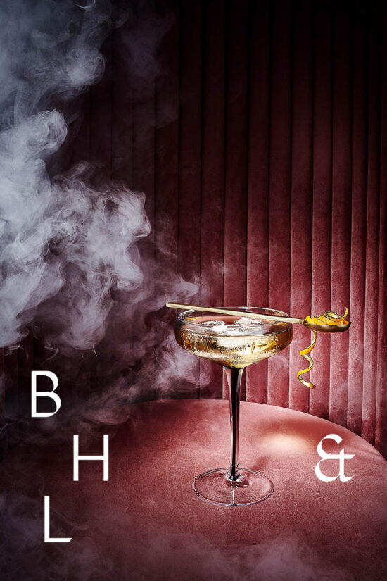 Honey Whisky cocktail photography in smoky pink bar - Anna Schneider drinks photographer
