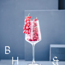 Food photography of frozen currants in a frozen glas on a light blue background