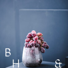 Food photography of frozen grapes in a frozen glas on a blue background