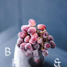 Food photography of frozen grapes in a frozen glas on a blue background